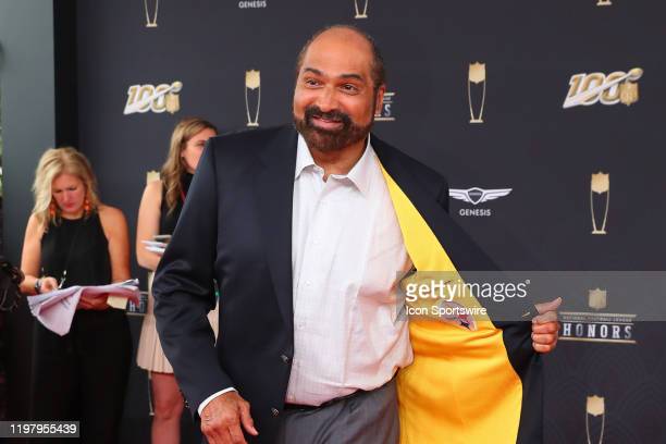 Cameron Heyward Pittsburgh Steelers Unsigned Carries Franco Harris Flag for The 50th Anniversary of Immaculate Reception Photograph