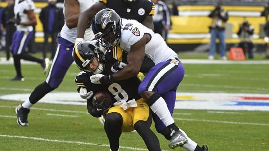 Kenny Pickett (#8) gets hit by the Baltimore Ravens Roquan Smith (#18) in Pittsburgh, PA. |