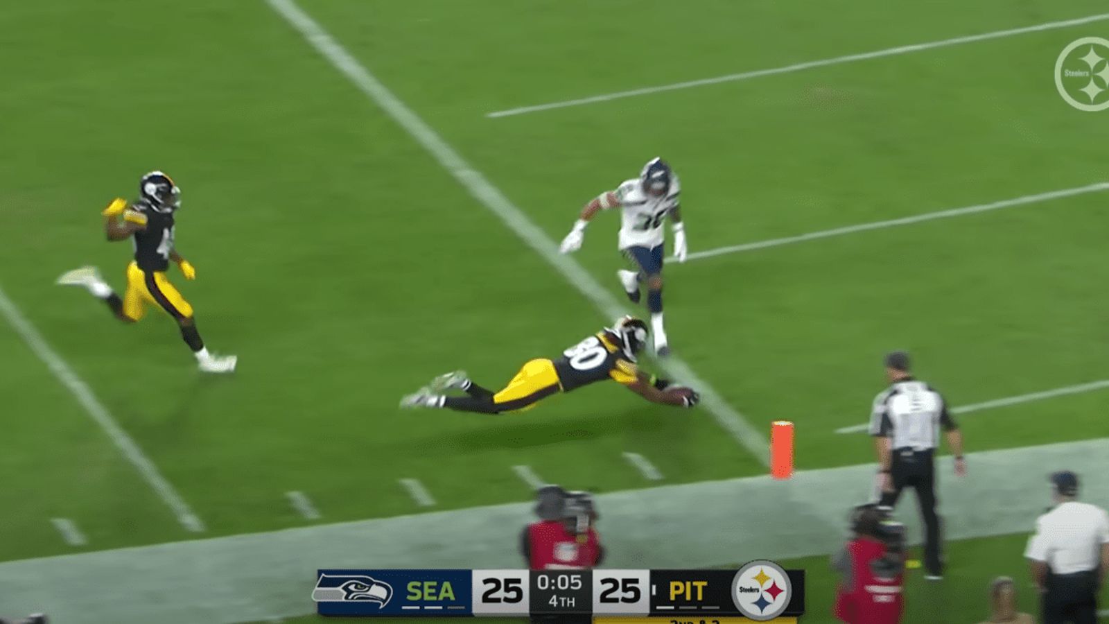 Pittsburgh Steelers wide receiver Steven Sims shakes a pair of Seattle  Seahawks on a slippery 38-yard punt return