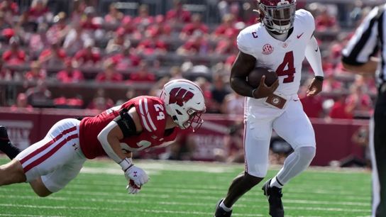 Alabama's Jalen Milroe tries to get past Wisconsin's Hunter Wohler during the first half of their matchup in 2024.