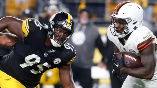 Steelers' DL Keeanu Benton going for a tackle on Browns' Nick Chubb.