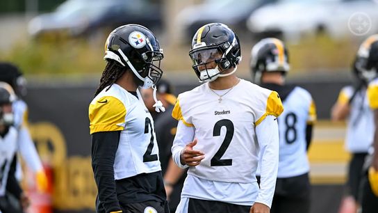 Steelers' Justin Fields and Najee Harris speaking with each other during practice.