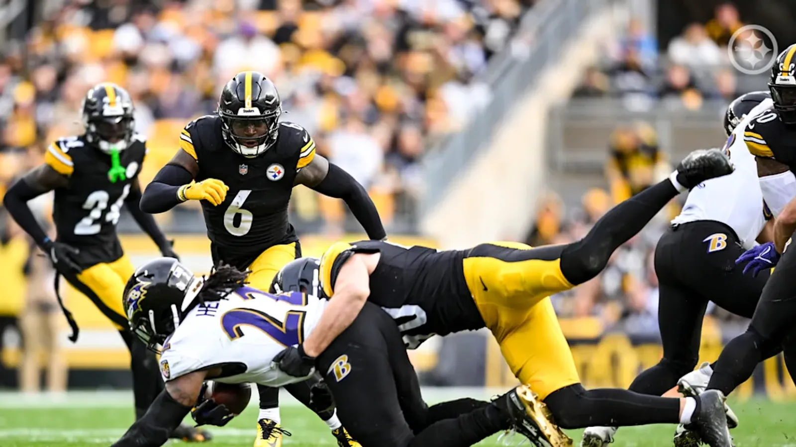 Pittsburgh Steelers' TJ Watt and Patrick Queen make a play on Ravens' running back Derrick Henry.