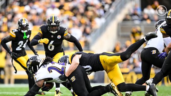 Pittsburgh Steelers' TJ Watt and Patrick Queen make a play on Ravens' running back Derrick Henry.