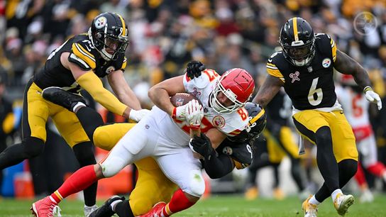 Pittsburgh Steelers' TJ Watt, Patrick Queen, and Larry Ogunjobi making a tackle on Chiefs' tight end Travis Kelce in 2024.