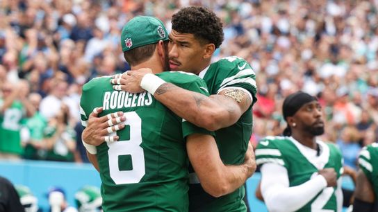 Steelers quarterback Aaron Rodgers hugging former teammate Allen Lizard while playing for the New York Jets