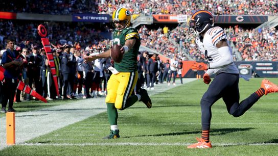 Former Green Bay Packers quarterback Aaron Rodgers scoring a touchdown against formal division rival, the Chicago Bears Former Green Bay Packers quarterback Aaron Rodgers scoring a touchdown against formal division rival, the Chicago Bears